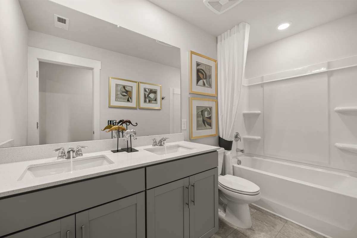 Upstairs secondary bathroom has dual sinks