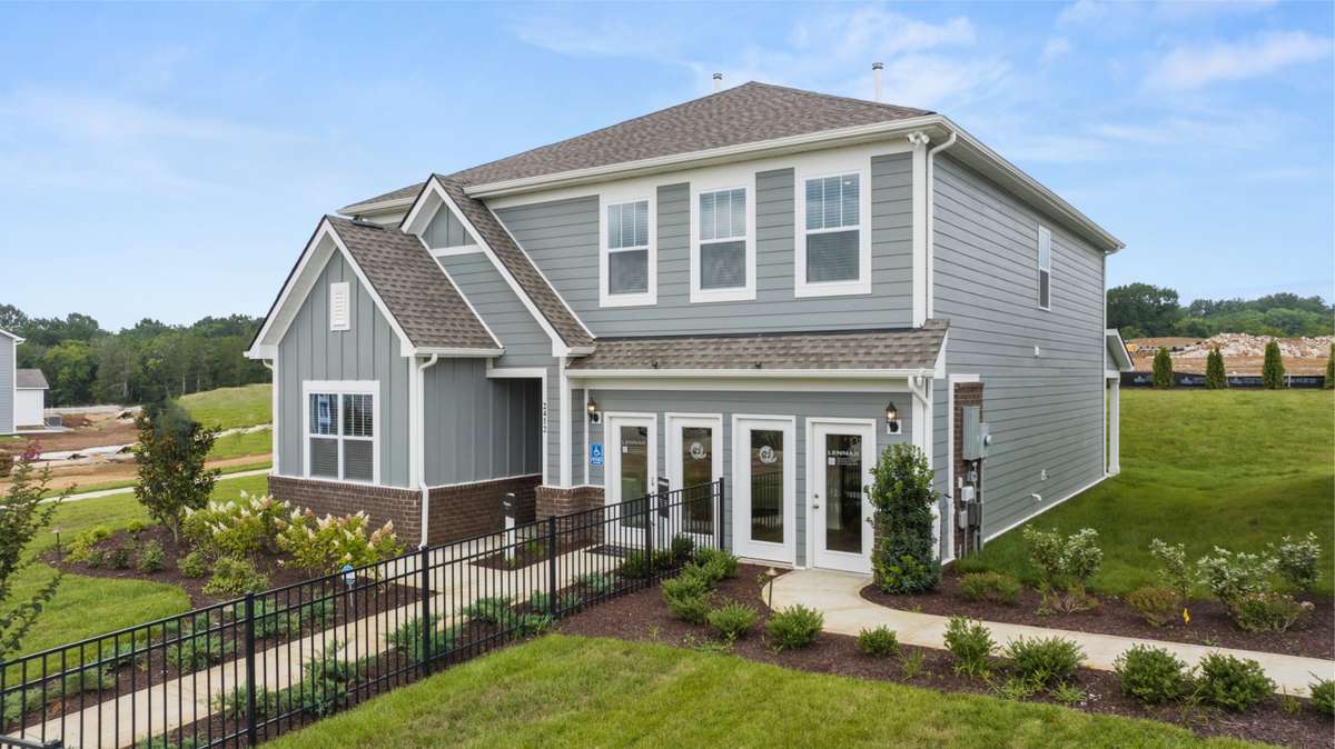 Since these photos, the driveway has been installed and garage is ready for your two cars! The black model fence has also been removed.