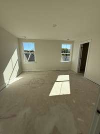 Spacious bedroom with soft natural light, neutral walls, and ample room for personalized furnishings and décor.