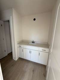 Timeless bathroom featuring a white vanity, sleek fixtures, and warm flooring.