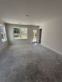 Spacious bedroom with soft natural light, neutral walls, and ample room for personalized furnishings and décor.