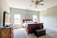 This lovely primary suite on the main level has double windows and is large enough for all of your furniture.