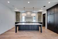 Oversized Eat-In Kitchen with Huge Island and Contemporary Cabinets and Jen-Air Professional Appliances