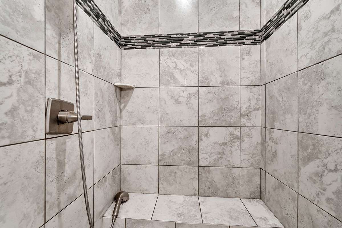 Walk-in shower with hand held attachment