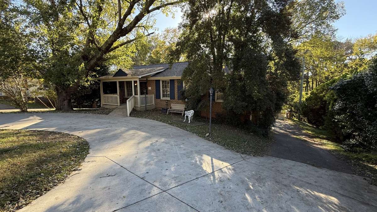 Front Circle Drive with Driveway to the Back of Home leading to the 2 Car Garage