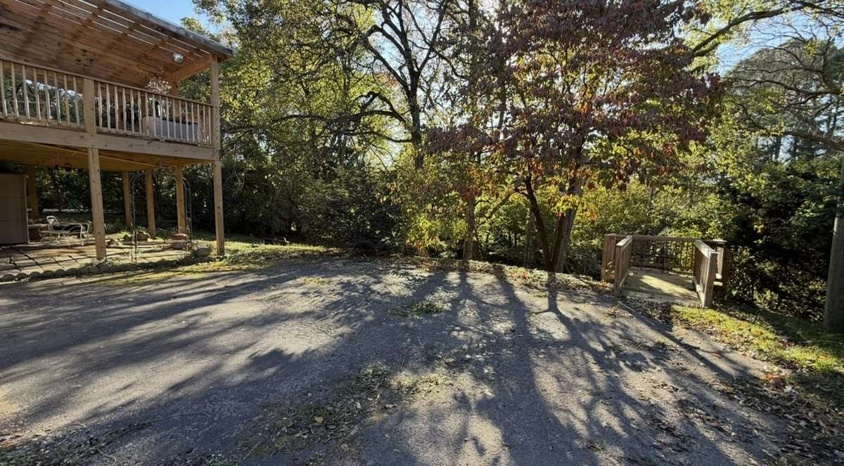 Parking area in Back of Home with Coevered Patio and Covered Deck with also a Small Deck.