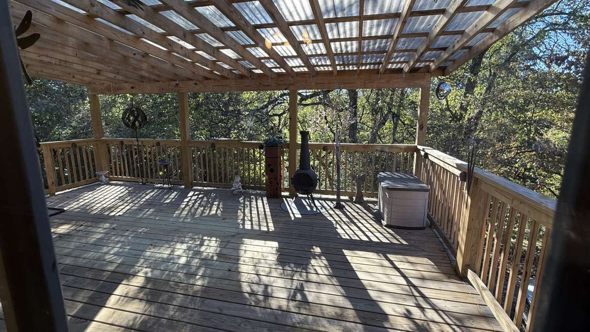 Covered 16x25 Deck with a View of the Back Yard and Trees Providing Privacy