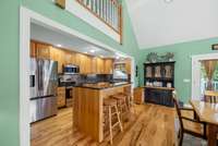 Kitchen with 2 sinks, and a island bar with seating area.