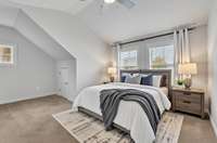 Virtually staged spacious bedroom with two closets.