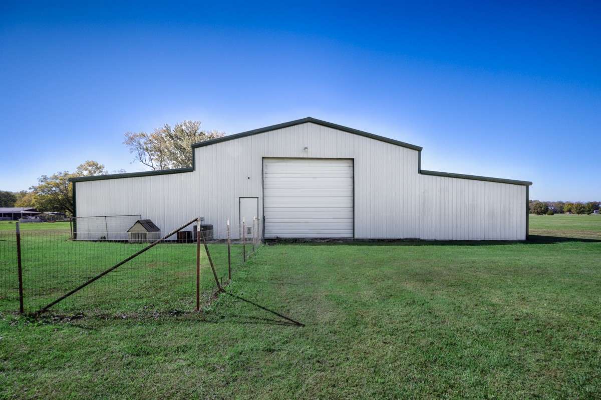 Back of building- Fenced dog area, single rollup door to main storage area