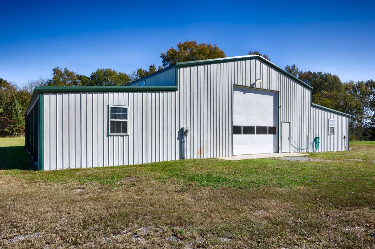 Front of building- Single 14x14 overhead door, concrete pad, and pedestrian door