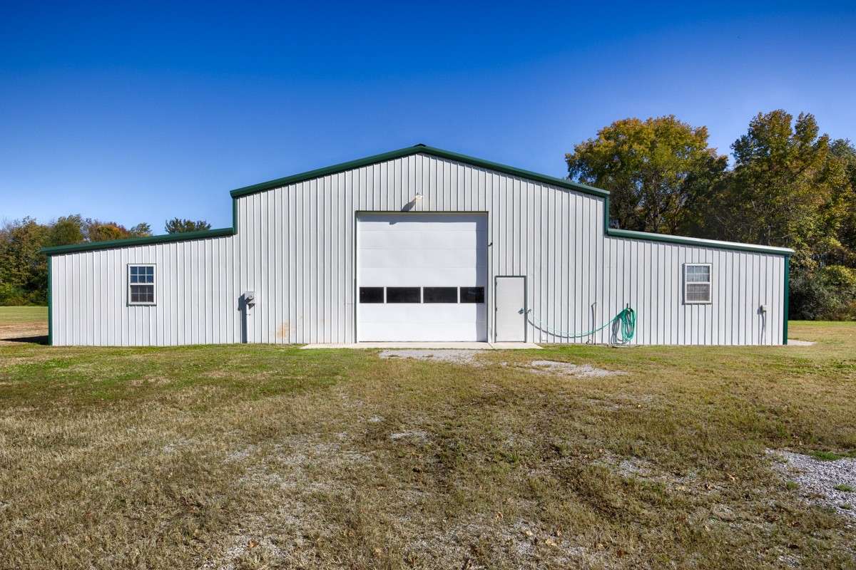 Front of building- Single 14x14 overhead door, concrete pad, and pedestrian door