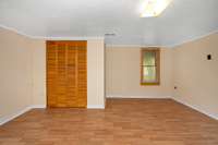 Bedroom- laminate flooring, crown molding