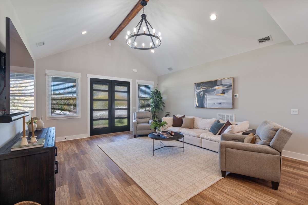 The open concept of this living area is filled with natural light and neutral soothing colors.