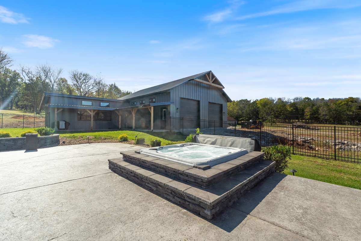Built in hot tub with raised stone surround—perfect for unwinding after a long day and enjoying peaceful evenings outdoors.