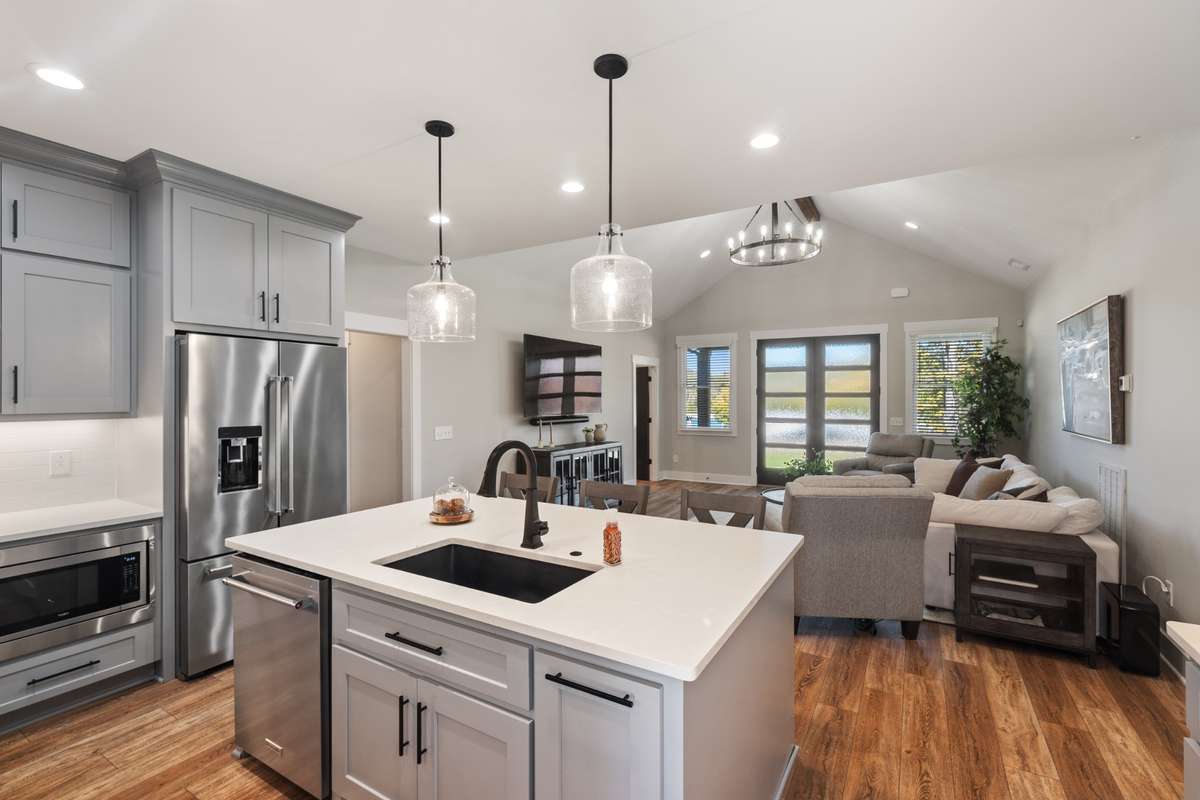 Perfectly designed kitchen layout with stainless steel appliances and oversized island make preparing meals fun while still being accessible to the living space activity.