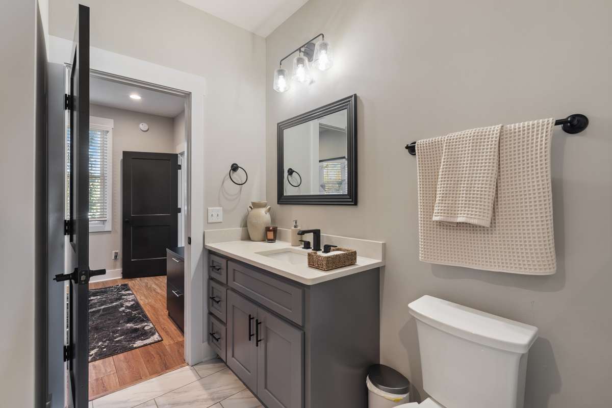 The second bath is accessible to the front bedroom and to the hallway leading to the additional secondary bedroom and bonus room.