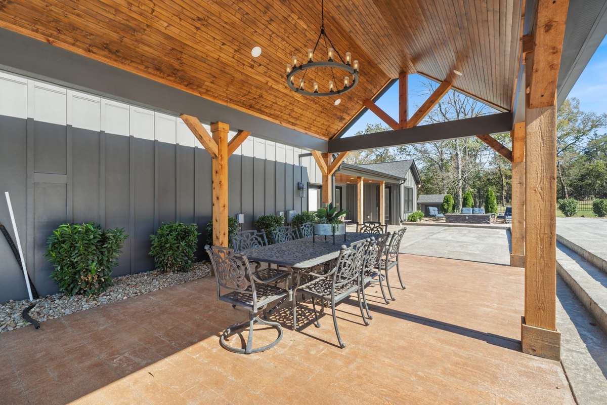 Covered outdoor dining pavilion with vaulted wood ceilings and timber beams—an ideal setting for al fresco meals, celebrations, and relaxed evenings outdoors.