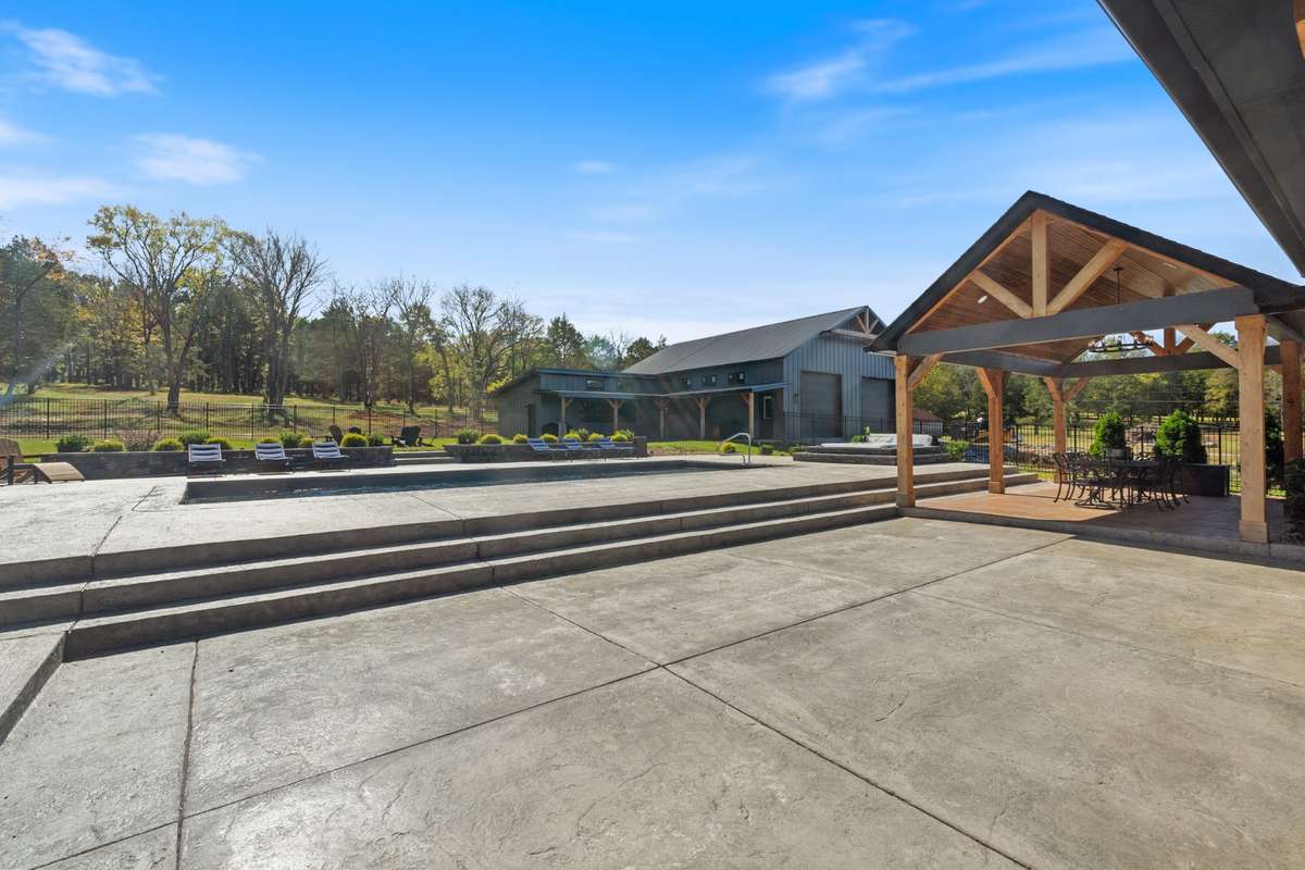 Expansive outdoor entertaining around the pool and covered pavilion. Room to gather—designed for unforgettable weekends and summer nights.