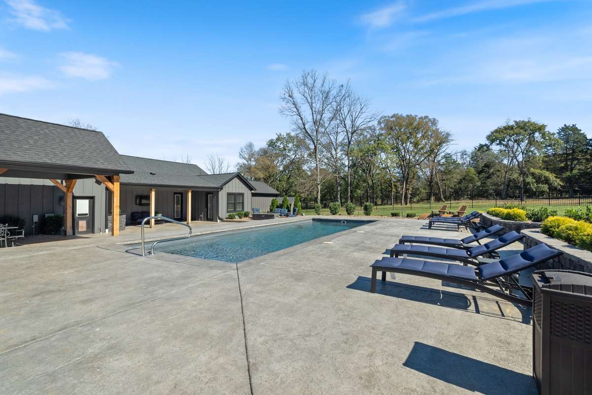 Resort-style 45 x 15 heated saltwater pool with expansive patio space for lounging, entertaining, and enjoying sunny days with family and friends.