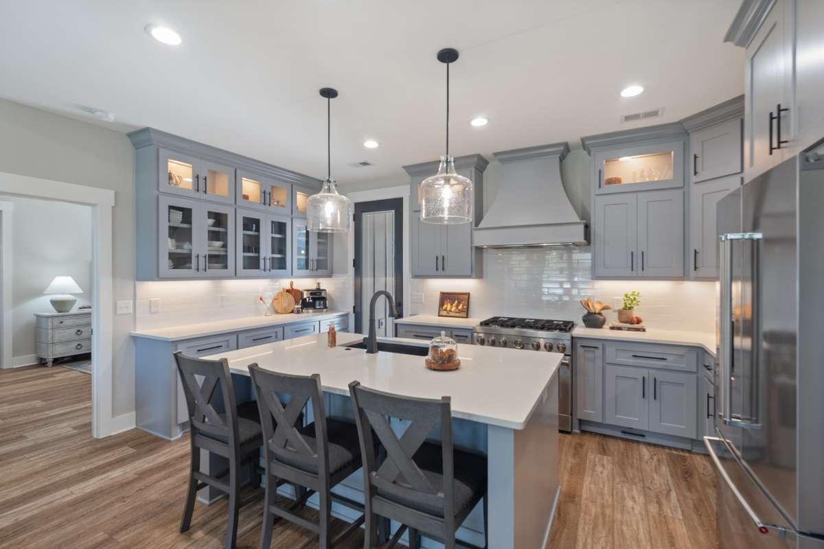 Chef-inspired kitchen with a large gathering island, custom cabinetry, and beautiful lighting—designed for easy everyday meals and effortless entertaining.