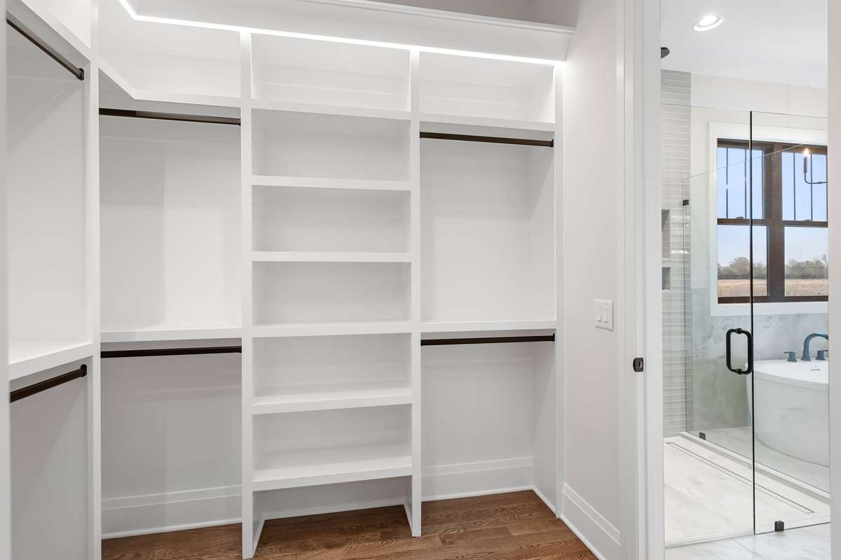 HIS AND HER CLOSETS WITH BUILT IN LIGHTS