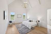 The Primary Suite Features A Vaulted Ceiling With Beams
