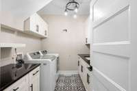 Yes, please! Who doesn't love an actual laundry ROOM? With multiple cabinets, extra shelving, dual counters, and a laundry sink, this one is a winner for sure!