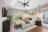 The Primary Bedroom has been virtually staged to provide you with an idea of how you might like to decorate and fill this ample space. Notice the pretty hanging lights on each side of the bed...