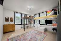 Bed 2 is a great size and features two sets of double windows for tons of natural light and hardwood floors.