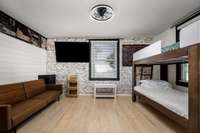 Bedroom 3 has hardwood floors, light fixture with ceiling fan and two windows.