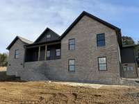 475 Bridle Path Lane Hartsville TN Lot 61 
This home is under construction featuring brick and hardy board exterior, black aluminum finishes, with side entry garage.