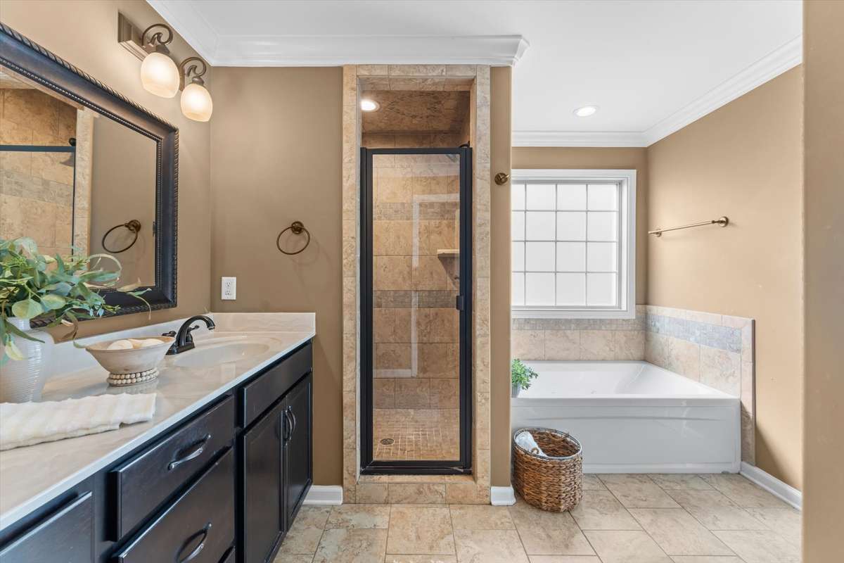 Primary bath suite with a jetted tub, fully tiled shower, and double vanities!