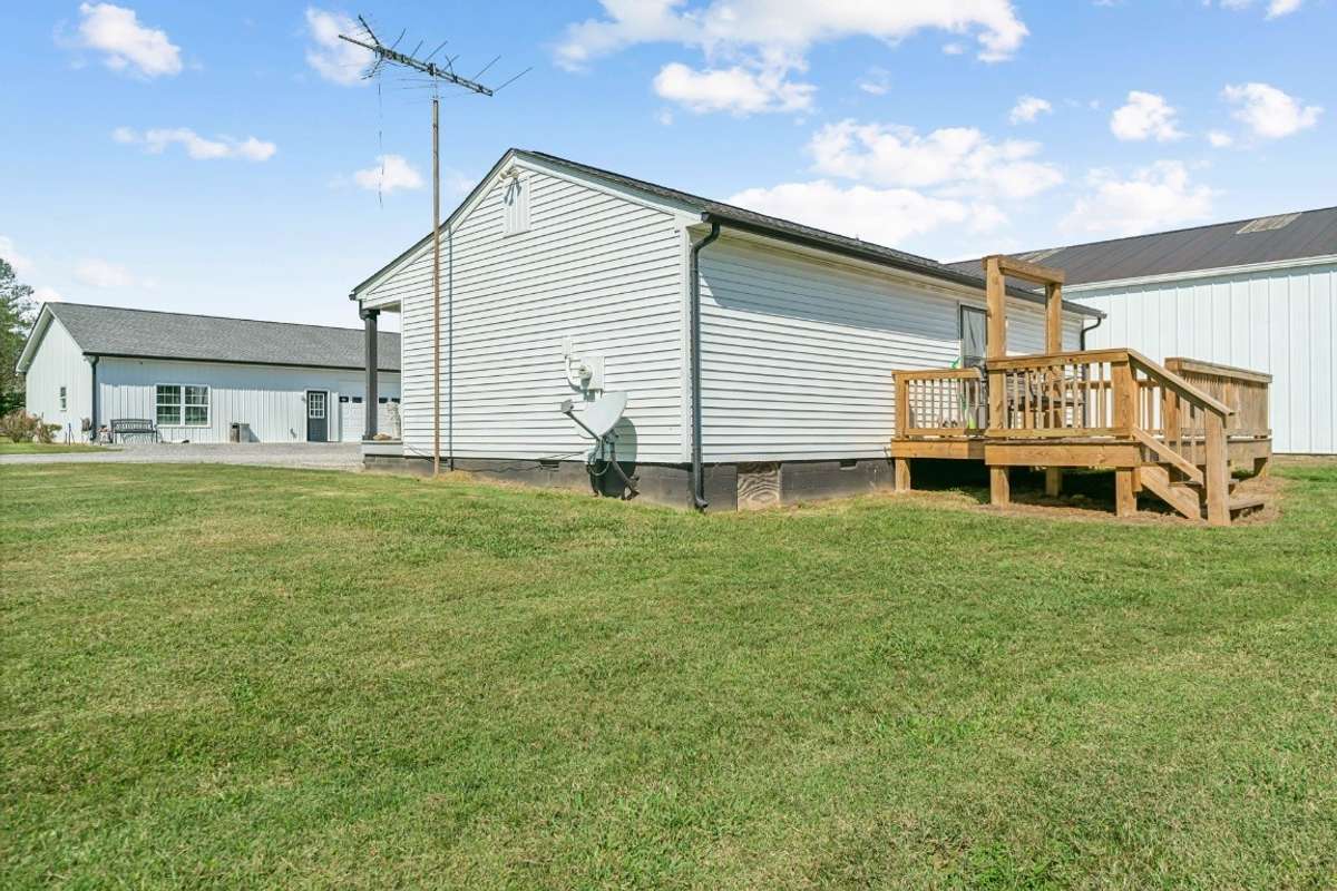 Guest House With Back Deck with Shop beside and Party House across