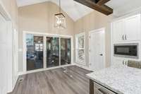 This slider leads to a wonderful screened porch, complete with a gas fireplace and mounted television. You will love spending time out here...