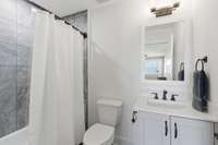 This private bath services the Bonus Room and features a tub/shower combo...