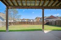 The back patio is HUGE and COVERED!!!! Outdoor lightening as well as double ceiling fans, enjoy your private fenced backyard no matter rain or shine!