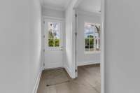 Step into this inviting home through a stylish front door and be greeted by a bright, modern hallway with hardwood floors.