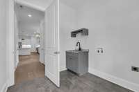 Attached 2-car garage and utility room with rear entrance/exit.