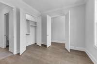 A spacious closet with custom built-in shelving (an upgraded feature) keeps everything neatly organized and within reach.