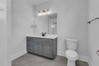 The full bath features tiled floors and a versatile shower/tub combo, combining style and functionality for everyday comfort.