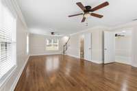 This living room has an abundance of beautiful natural light. There is a full bathroom for visitors as well.