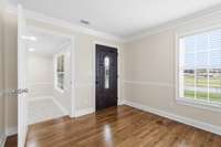 Principal entrance access the incredibly spacious and beautiful living room area and to the kitchen to the right.