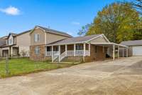 Southern Traditional or Country-inspired design. Home provides a lot of parking space, car-pot and a detached car garage.