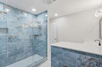 Principal bathroom exudes luxury and tranquility, highlighted by breathtaking blue marble-look tile.