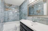 Full bathroom on the second level beautifully remodeled features breathtaking blue marble-look tile.