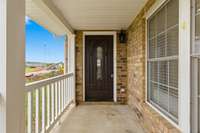 The inviting front porch offers the perfect spot to unwind and enjoy peaceful afternoons.