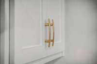 Kitchen cabinet features gold accents