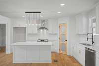 Kitchen island with granite, stainless steel appliances, glass pantry door with craftsman style cabinets is waiting for you.
