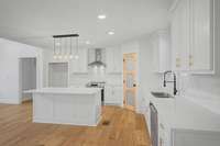 Kitchen island with granite, stainless steel appliances, glass pantry door with craftsman style cabinets is waiting for you.